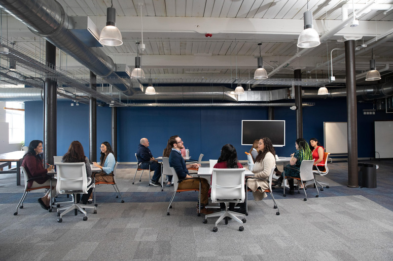 a group of students sitting at a table collaborating